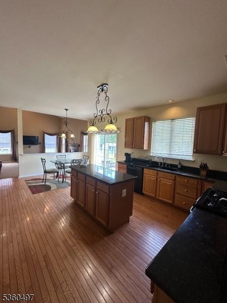 30 Julie Ct, Franklin Twp, NJ 08873 - kitchen with dishwasher, dark countertops, a sink, a kitchen island, and hardwood / wood-style floors