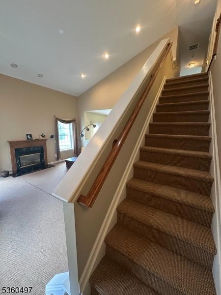 30 Julie Ct, Franklin Twp, NJ 08873 - stairway featuring a premium fireplace, carpet floors, and recessed lighting