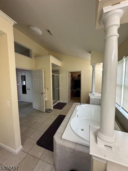 30 Julie Ct, Franklin Twp, NJ 08873 - full bathroom with decorative columns, vaulted ceiling, tile patterned flooring, a garden tub, and baseboards