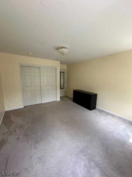30 Julie Ct, Franklin Twp, NJ 08873 - unfurnished living room featuring light colored carpet and baseboards