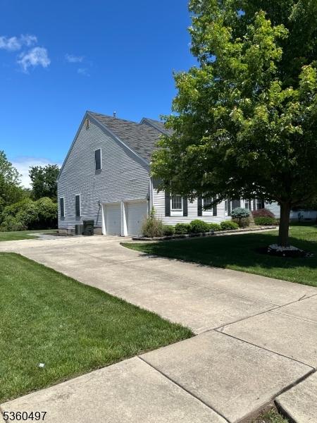 30 Julie Ct, Franklin Twp, NJ 08873 - view of property exterior featuring a garage, a lawn, and concrete driveway