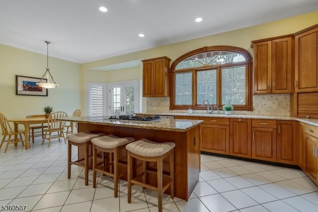 10 Beacon Hill Dr, Chester Twp, NJ 07930 - kitchen featuring decorative backsplash, a center island, a sink, brown cabinets, and light stone counters