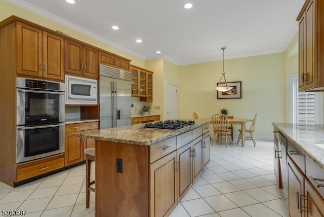 10 Beacon Hill Dr, Chester Twp, NJ 07930 - kitchen with built in appliances, recessed lighting, light stone countertops, brown cabinetry, and a center island