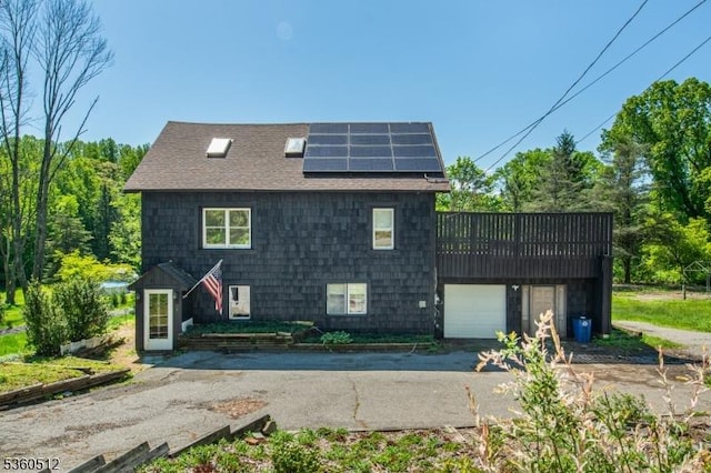 98 Asbury Rd, Independence Twp, NJ 07840 - view of side of property with solar panels, a shingled roof, a garage, and asphalt driveway