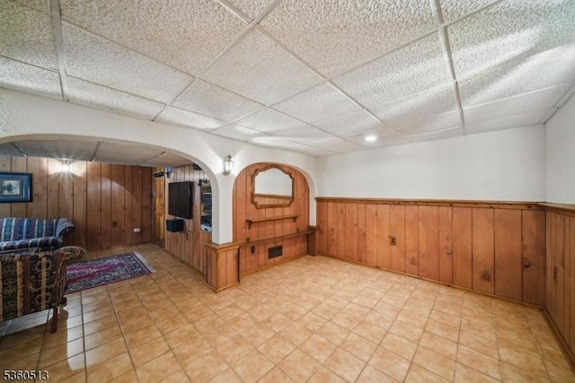 15 Fox Run, Parsippany-Troy Hills Twp, NJ 07834 - unfurnished room with wooden walls, a drop ceiling, a wainscoted wall, and arched walkways
