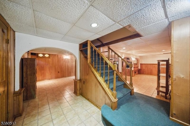 15 Fox Run, Parsippany-Troy Hills Twp, NJ 07834 - stairs featuring arched walkways, a paneled ceiling, wood walls, a wainscoted wall, and tile patterned floors