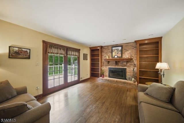 15 Fox Run, Parsippany-Troy Hills Twp, NJ 07834 - living room with built in shelves, wood finished floors, baseboards, and a brick fireplace