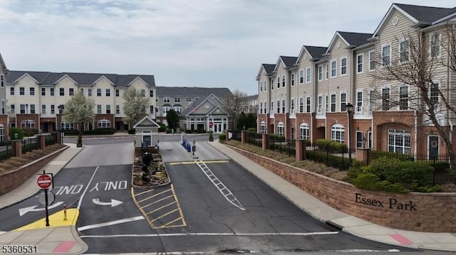 1007 Cunningham Ct Unit 1007, Belleville Twp, NJ 07109 - view of asphalt street with sidewalks, a residential view, curbs, traffic signs, and street lights