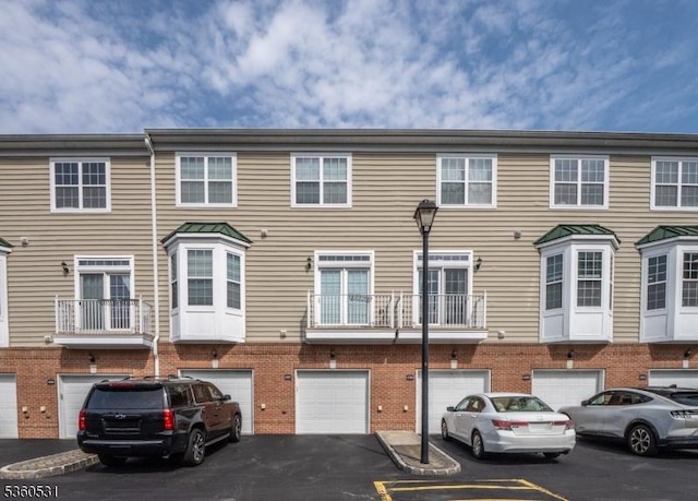 1007 Cunningham Ct Unit 1007, Belleville Twp, NJ 07109 - view of property with driveway, a garage, and brick siding