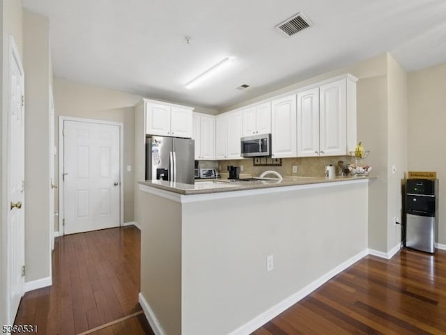 1007 Cunningham Ct Unit 1007, Belleville Twp, NJ 07109 - kitchen with stainless steel appliances, dark wood-type flooring, white cabinets, a peninsula, and decorative backsplash