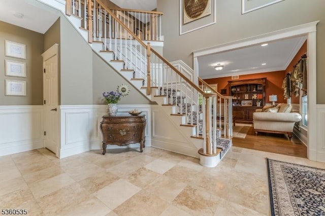 19 Britton Rd, Delaware Twp, NJ 08559 - stairs featuring wainscoting, a decorative wall, ornamental molding, and a towering ceiling