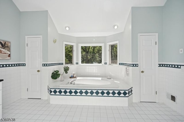 1 Colby Farm Rd, Chester Twp, NJ 07930 - bathroom featuring tile walls, tile patterned floors, a garden tub, and a wainscoted wall