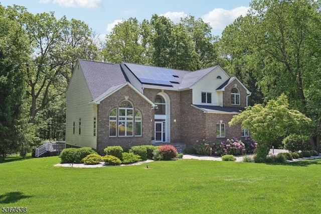 1 Colby Farm Rd, Chester Twp, NJ 07930 - view of front facade with brick siding, solar panels, and a front lawn