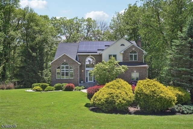 1 Colby Farm Rd, Chester Twp, NJ 07930 - traditional-style home featuring solar panels, a front yard, a chimney, and brick siding