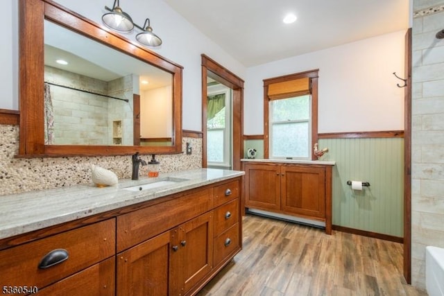 14 Lindberg Trl, Rockaway Twp, NJ 07866 - full bathroom with wood finished floors, vanity, a wainscoted wall, tiled shower, and a tub to relax in