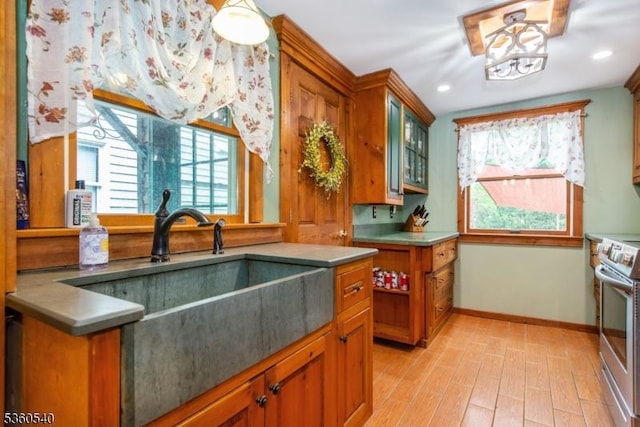14 Lindberg Trl, Rockaway Twp, NJ 07866 - kitchen with stainless steel range with electric cooktop, baseboards, light wood-style floors, glass insert cabinets, and brown cabinets