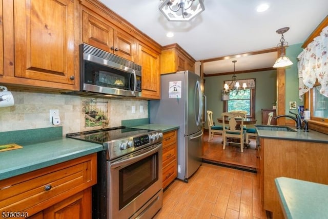 14 Lindberg Trl, Rockaway Twp, NJ 07866 - kitchen with appliances with stainless steel finishes, brown cabinets, a chandelier, light wood-style flooring, and crown molding