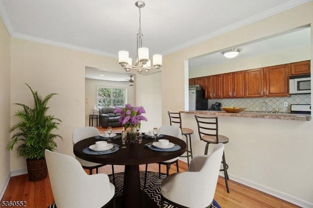 43A W Roselle Ave, Roselle Park Boro, NJ 07204 - dining area with a chandelier, light wood-style floors, ornamental molding, and baseboards