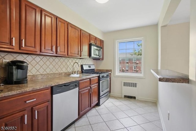 43A W Roselle Ave, Roselle Park Boro, NJ 07204 - kitchen with appliances with stainless steel finishes, radiator heating unit, a sink, decorative backsplash, and baseboards