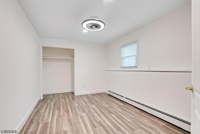 37 King George Rd, Warren Twp, NJ 07059 - unfurnished bedroom with baseboard heating, light wood-style floors, baseboards, and a closet