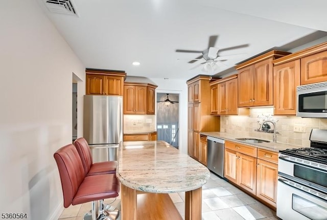 37 King George Rd, Warren Twp, NJ 07059 - kitchen with stainless steel appliances, a ceiling fan, a sink, a kitchen island, and tasteful backsplash