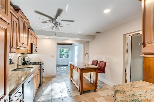37 King George Rd, Warren Twp, NJ 07059 - kitchen with appliances with stainless steel finishes, a sink, ceiling fan, light stone countertops, and baseboards