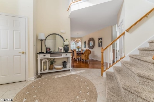 6 Apgar Ct, Raritan Twp, NJ 08822 - foyer entrance featuring tile patterned floors, stairway, a chandelier, baseboards, and a towering ceiling
