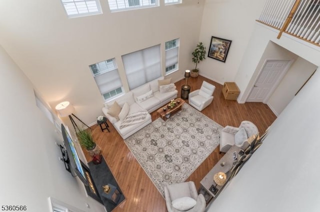 6 Apgar Ct, Raritan Twp, NJ 08822 - living area featuring a towering ceiling, wood finished floors, and baseboards