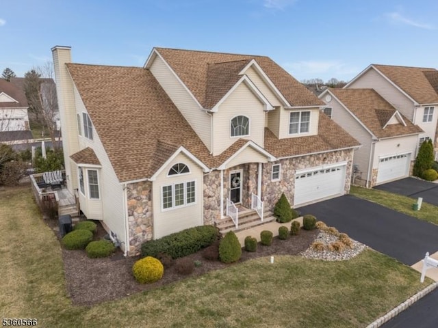 6 Apgar Ct, Raritan Twp, NJ 08822 - view of front of property with stone siding, driveway, a front lawn, and a shingled roof