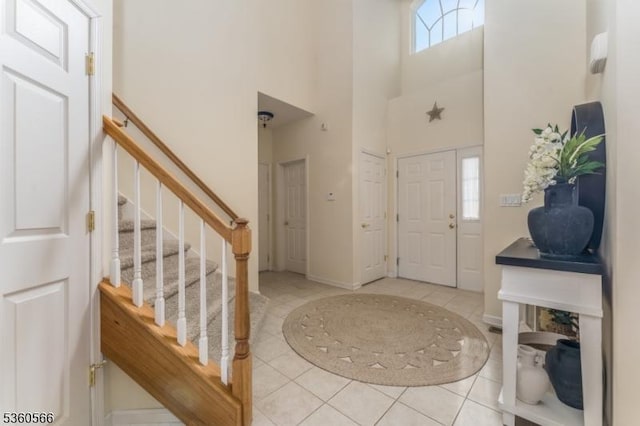6 Apgar Ct, Raritan Twp, NJ 08822 - foyer with stairs, light tile patterned floors, a towering ceiling, and baseboards