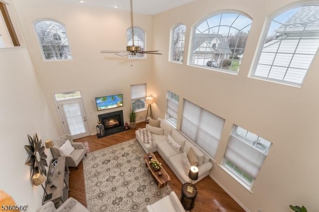6 Apgar Ct, Raritan Twp, NJ 08822 - living area featuring a high ceiling, wood finished floors, a fireplace with flush hearth, a ceiling fan, and plenty of natural light
