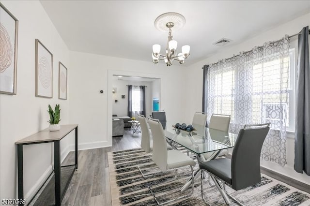 1036 Creger Ave, Union Twp, NJ 07083 - dining space with a chandelier, wood finished floors, and baseboards