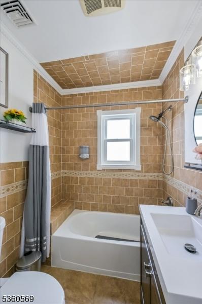 1036 Creger Ave, Union Twp, NJ 07083 - full bathroom with tile walls, crown molding, healthy amount of natural light, shower / tub combo, and tile patterned flooring