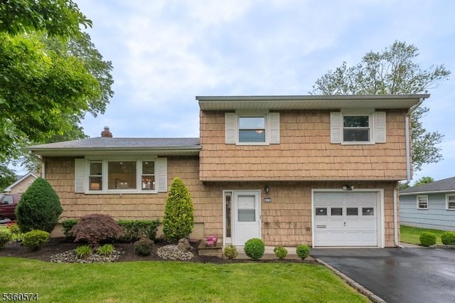 813 Riverbend Dr, Clark Twp, NJ 07066 - split level home featuring an attached garage, driveway, a front yard, and a chimney