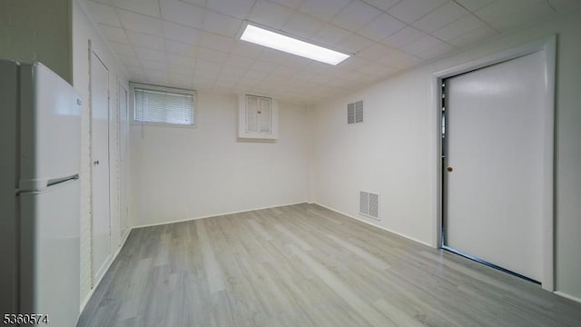 813 Riverbend Dr, Clark Twp, NJ 07066 - basement with freestanding refrigerator and wood finished floors
