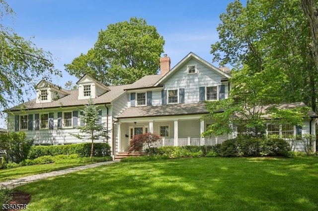 5 Barry Ln, Millburn Twp, NJ 07078 - view of front of property featuring covered porch, a front lawn, and a chimney