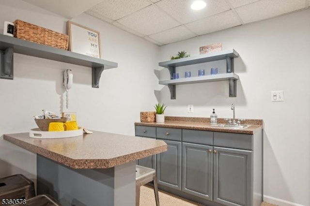 5 Barry Ln, Millburn Twp, NJ 07078 - kitchen featuring open shelves, a sink, a kitchen breakfast bar, and a paneled ceiling