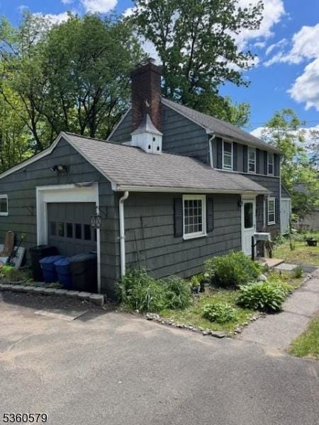 274 Diamond Hill Rd, Berkeley Heights Twp, NJ 07922 - view of property exterior featuring a chimney, a shingled roof, and a garage