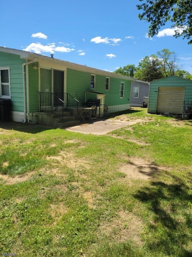 14 Douglas Dr, Jackson Twp, NJ 08527 - back of house featuring a lawn and an outbuilding