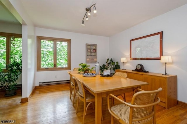 81 Coppermine Rd, Franklin Twp, NJ 08540 - dining room featuring baseboard heating, light wood-style flooring, rail lighting, and baseboards