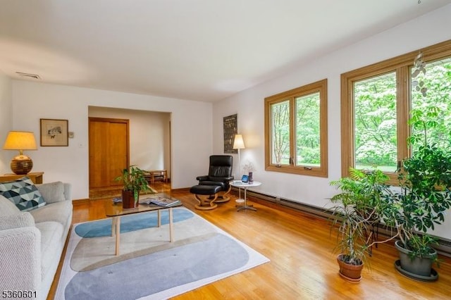 81 Coppermine Rd, Franklin Twp, NJ 08540 - living area featuring plenty of natural light, wood finished floors, and a baseboard radiator