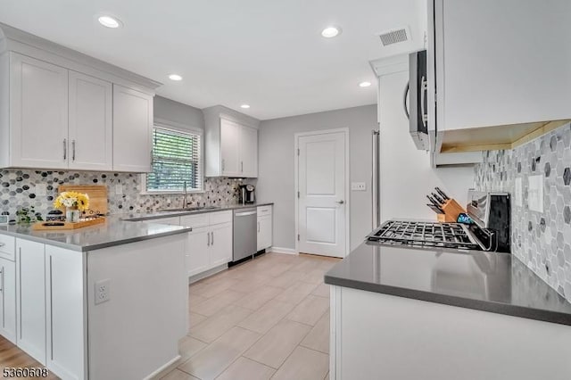 11 Anne St, Hillsborough Twp, NJ 08844 - kitchen with a sink, stainless steel appliances, tasteful backsplash, a peninsula, and recessed lighting
