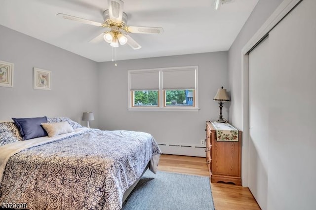 11 Anne St, Hillsborough Twp, NJ 08844 - bedroom featuring a baseboard heating unit, light wood-type flooring, a ceiling fan, and a closet