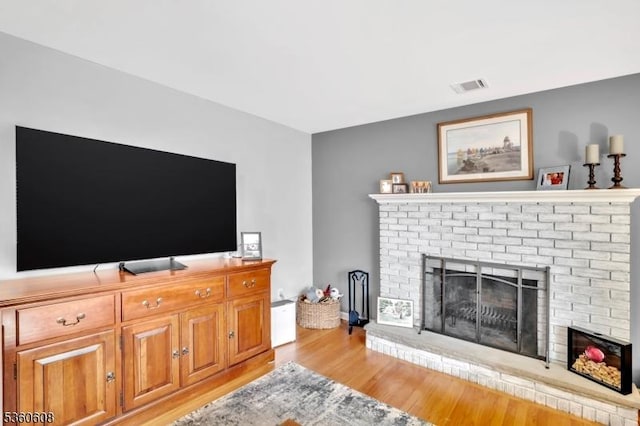 11 Anne St, Hillsborough Twp, NJ 08844 - living room featuring a brick fireplace and light wood-type flooring