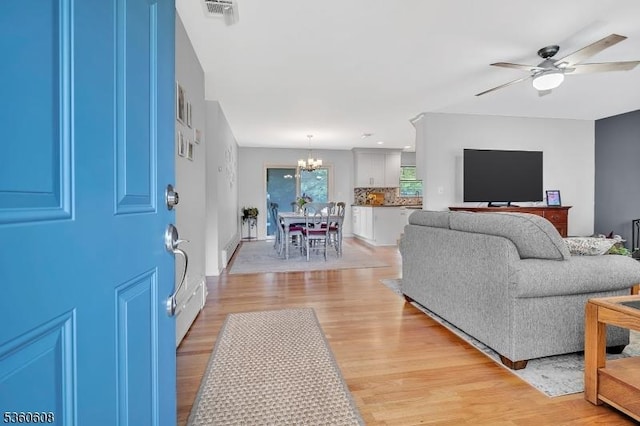 11 Anne St, Hillsborough Twp, NJ 08844 - living room with a chandelier, light wood-type flooring, and ceiling fan
