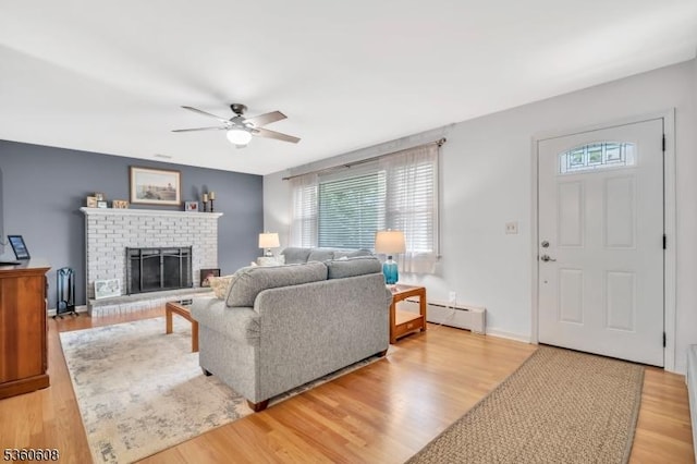 11 Anne St, Hillsborough Twp, NJ 08844 - living room with a baseboard heating unit, healthy amount of natural light, a ceiling fan, and a brick fireplace