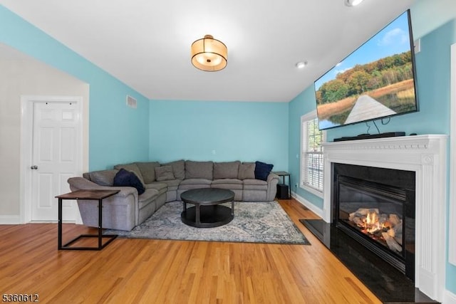 143 Oak St, Bridgewater Twp, NJ 08807 - living room with wood finished floors, a fireplace with flush hearth, and baseboards