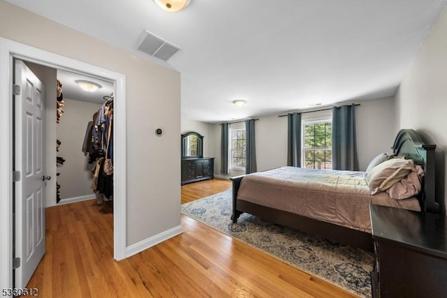 143 Oak St, Bridgewater Twp, NJ 08807 - bedroom featuring a walk in closet, light wood-style floors, and baseboards