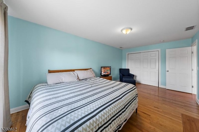 143 Oak St, Bridgewater Twp, NJ 08807 - bedroom featuring a closet, wood finished floors, and baseboards