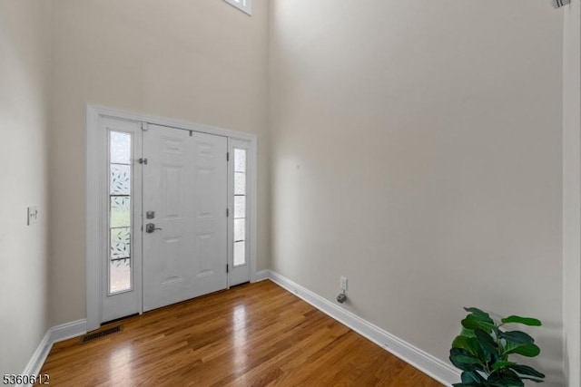 143 Oak St, Bridgewater Twp, NJ 08807 - foyer featuring plenty of natural light, baseboards, wood finished floors, and a high ceiling